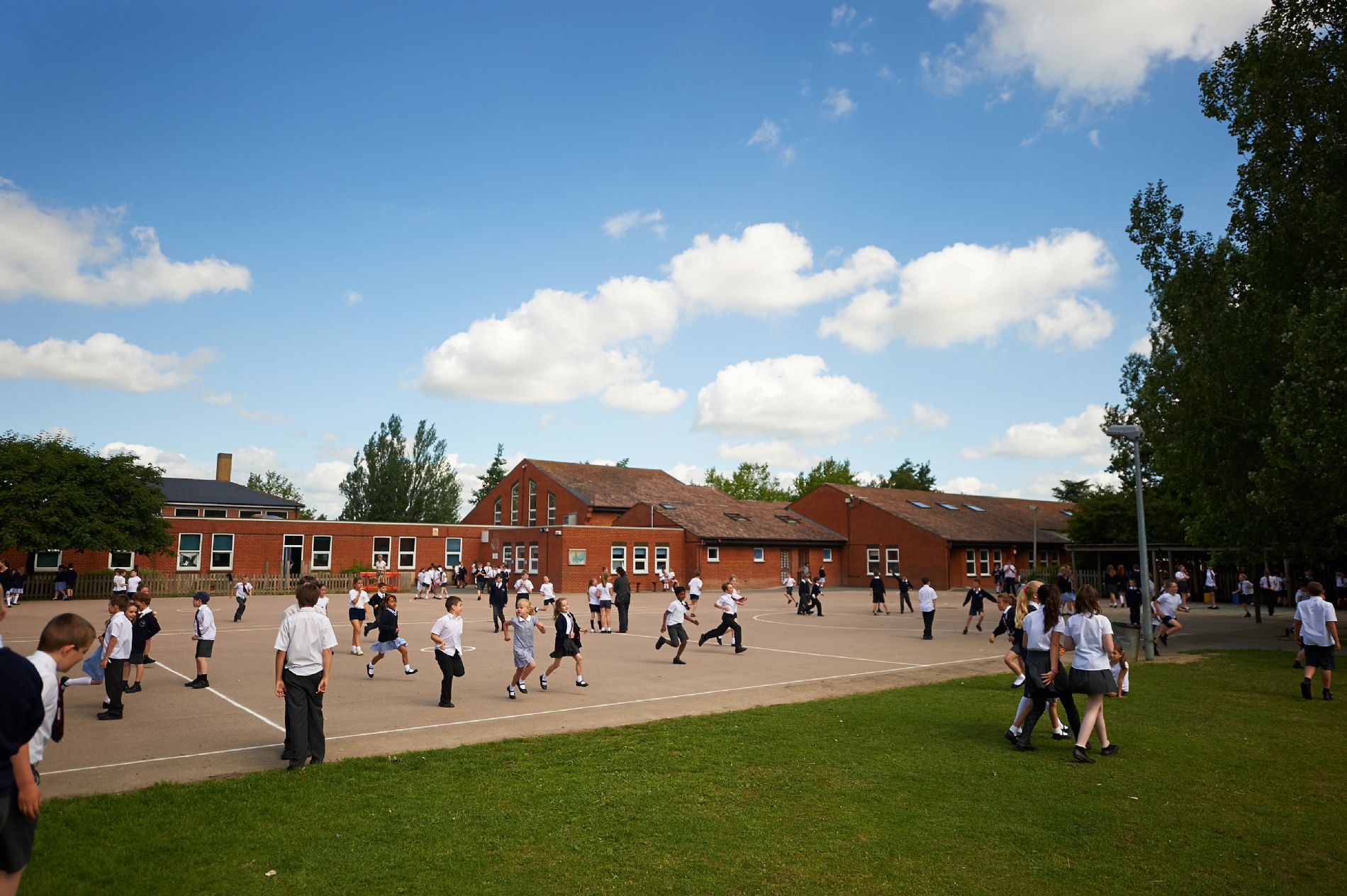 lots of children running at play time in the play ground