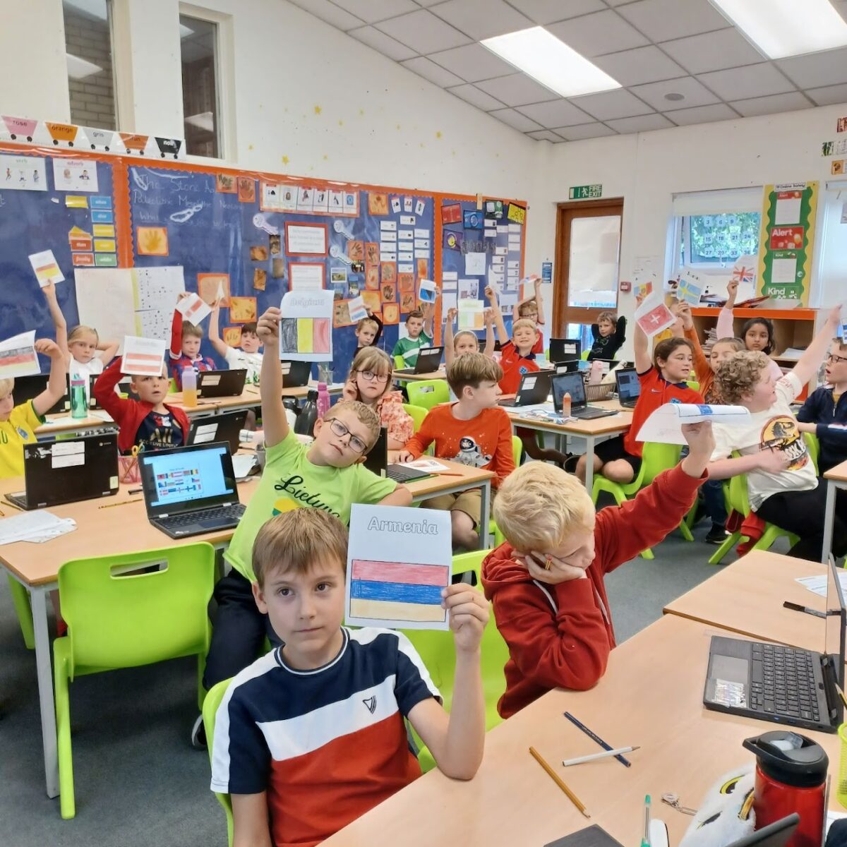 Children celebrating International Languages Day by drawing pictures of flags from countries around the world.