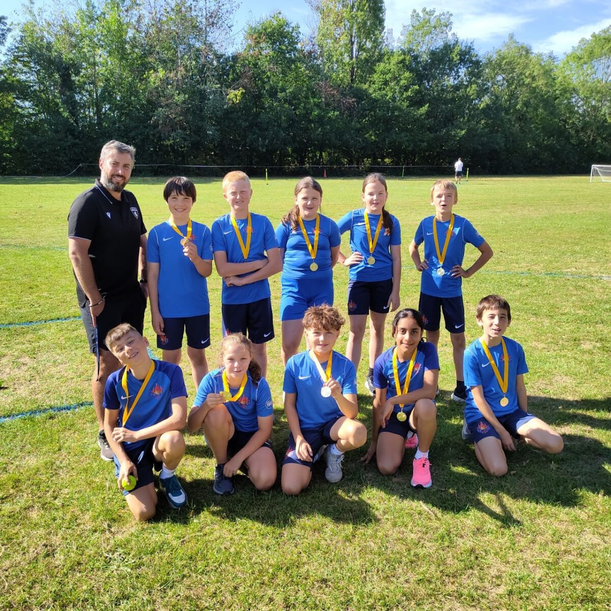 Photo of the Paddock Wood Primary Academy Rounders Team posing for the camera together outdoors.